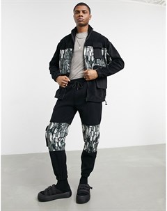 Черные зауженные джоггеры из теплого флиса с абстрактными камуфляжными вставками и карманами в утили Asos design