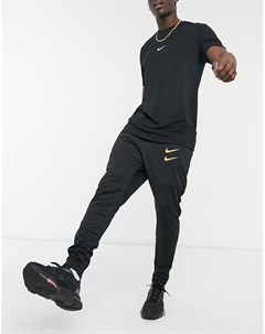 Черные джоггеры с золотистым логотипом галочкой Nike